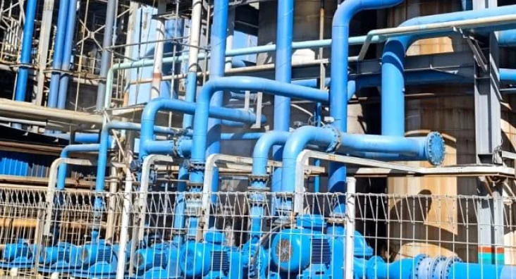 Anti-corrosion coated blue pipe structures at an industrial plant