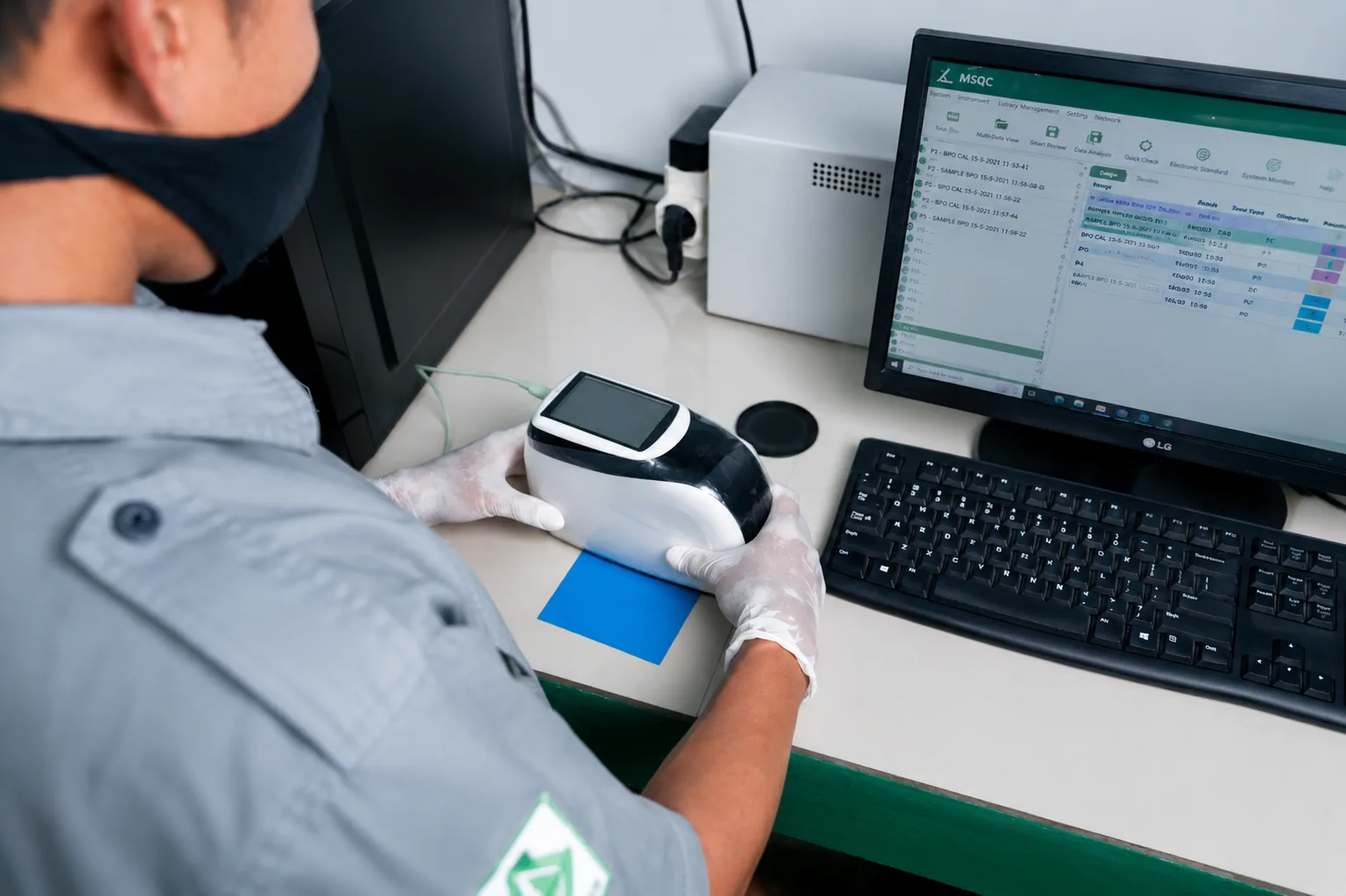 QC analyst verifying color accuracy with a spectrophotometer and MSQC software